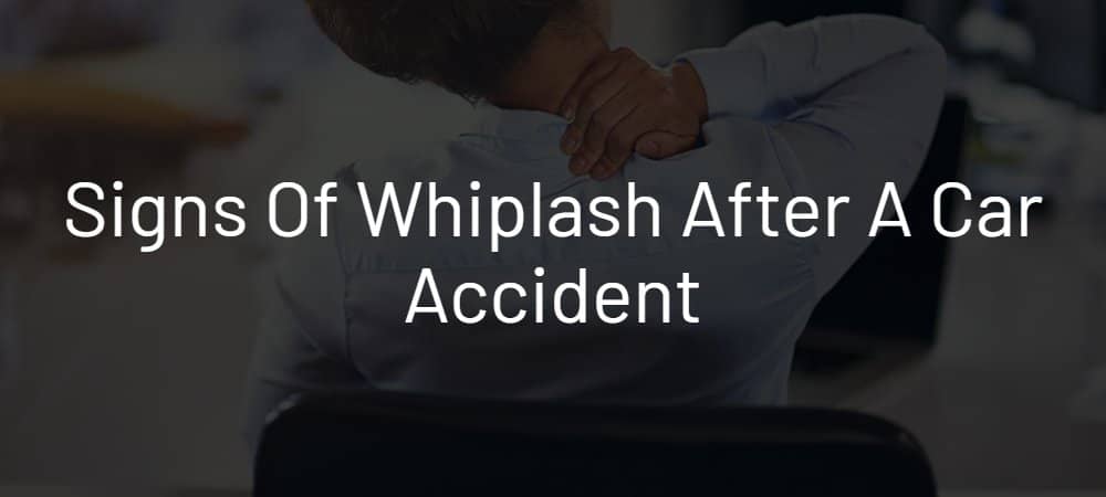 Signs of Whiplash. Person holding back of neck due to pain.
