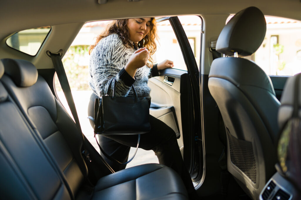 Latin big woman requesting a rideshare service car