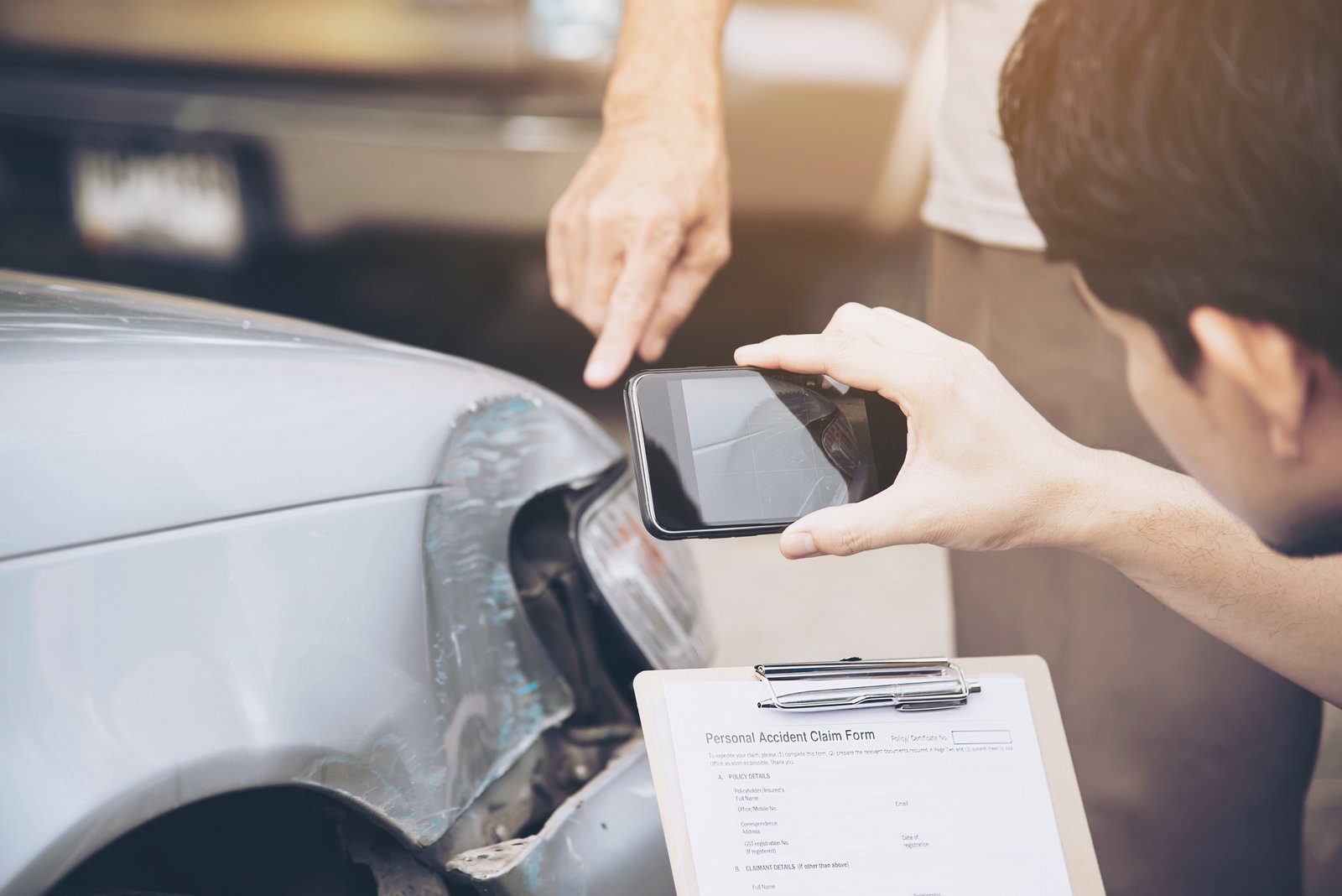 Insurance agent reviewing paperwork after a car accident claim