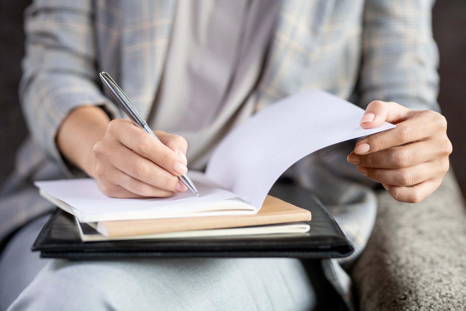 Person reviewing and documenting pain and suffering notes after a Nebraska accident